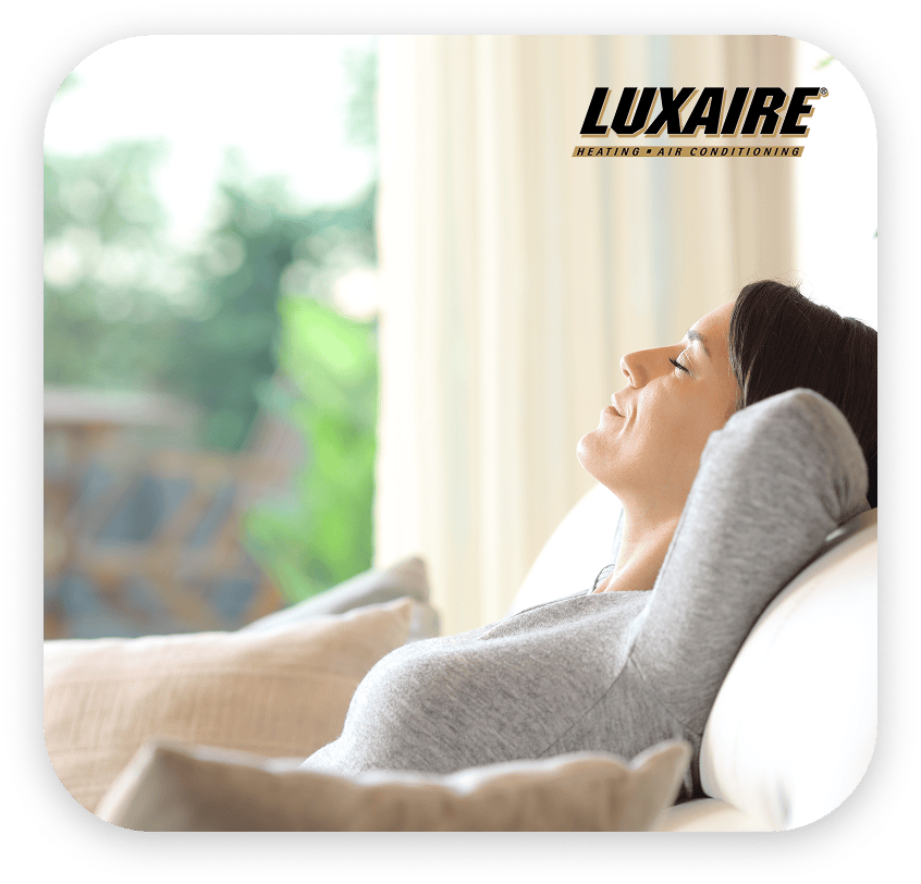 HVAC experts trust great equipment. Female homeowner enjoying her Luxaire heating and cooling equipment.